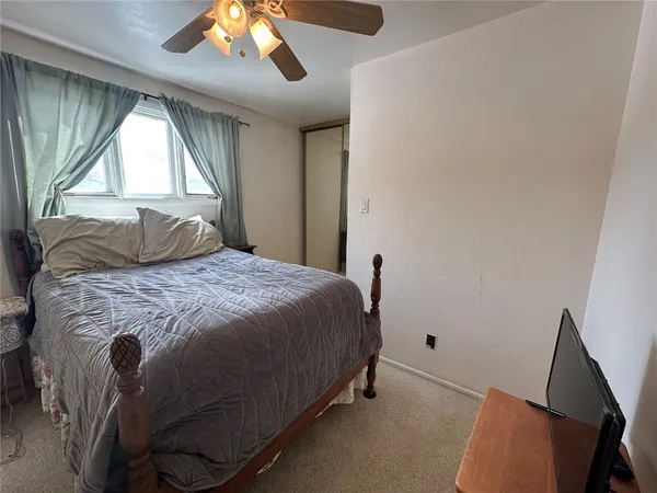 a bedroom with a bed and window