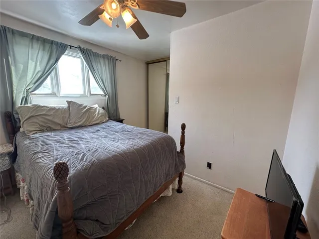 a bedroom with a bed and window