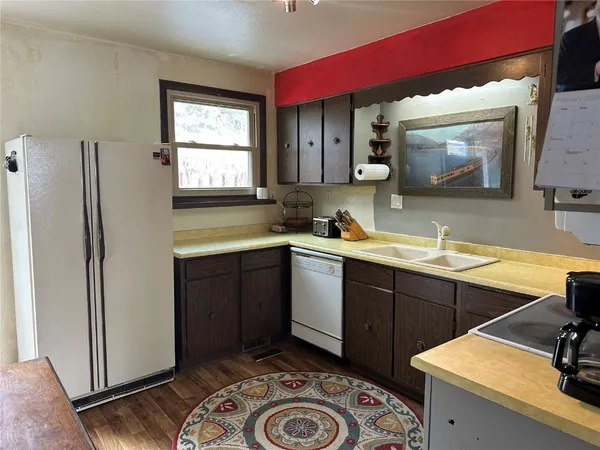 a kitchen with a sink stove and refrigerator