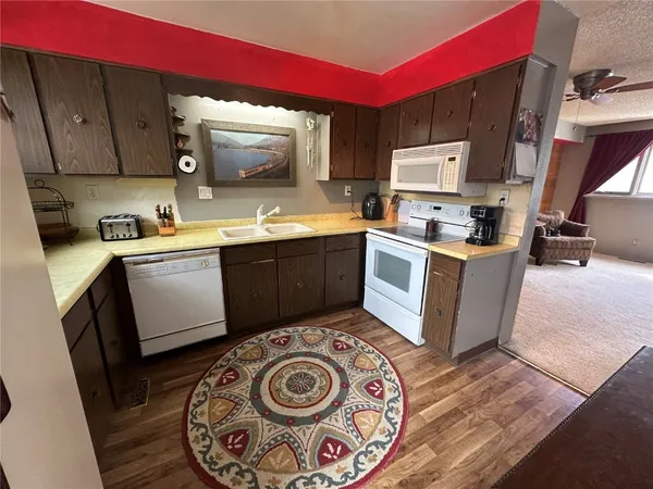 a kitchen with a sink a stove and cabinets