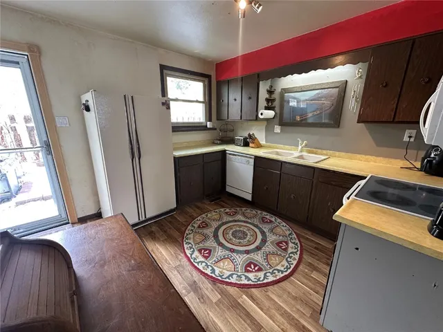 a kitchen with a sink a stove and cabinets
