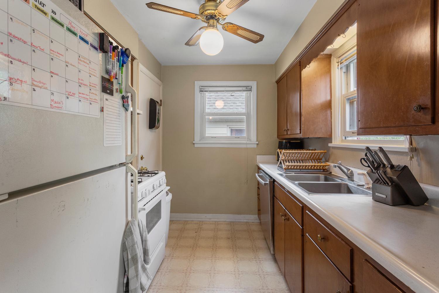 1117 West Union Street Champaign, IL 61821 - Photo 16 of 29 a kitchen with stainless steel appliances a stove a refrigerator and a sink with wooden floor