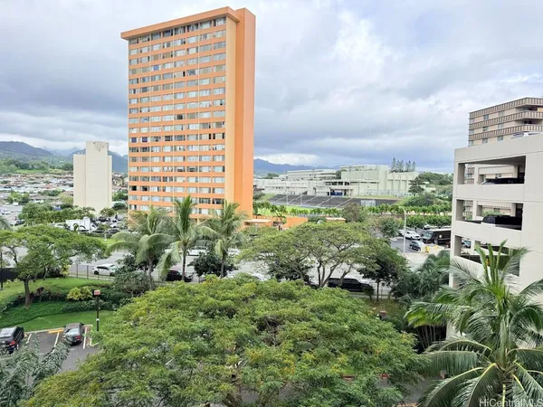 a view of a garden with tall buildings