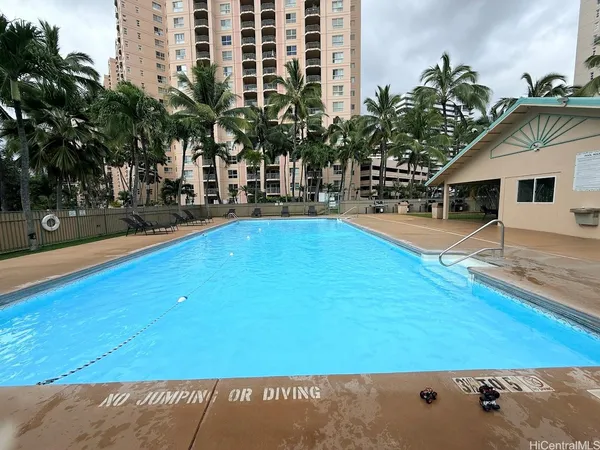 a view of swimming pool with outdoor seating and plants