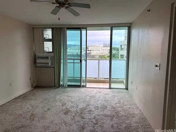 an empty room with windows and closet