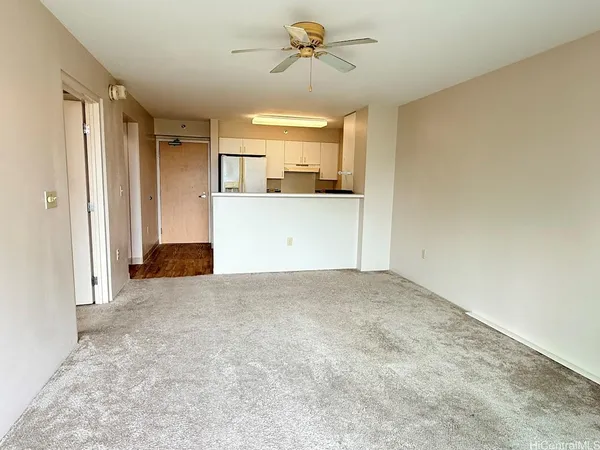 a view of a kitchen with a sink and a refrigerator