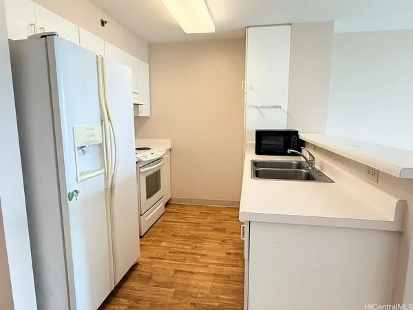 a kitchen with a refrigerator a stove top oven and a refrigerator