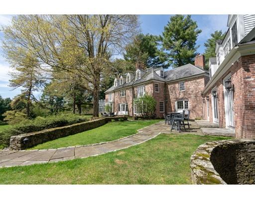 219 Dedham Street Dover, MA 02030 - Photo 5 of 30 a front view of a house with garden and trees