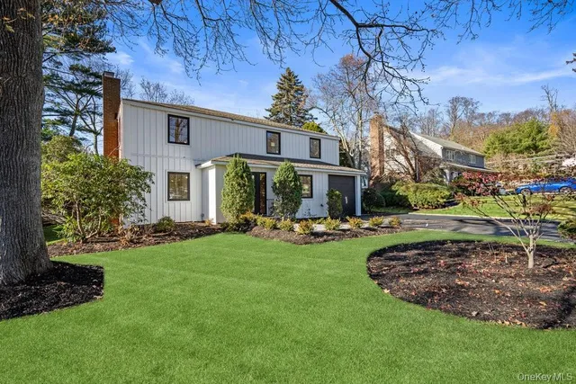 a view of a house with backyard sitting area and garden