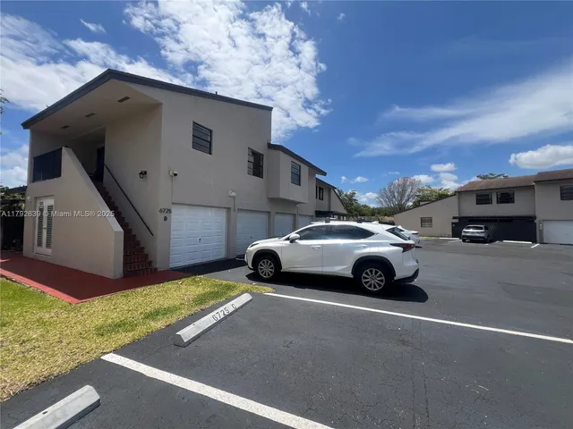 a view of a car parked in front of a house