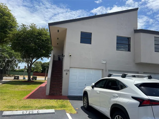 a view of front door of house with yard