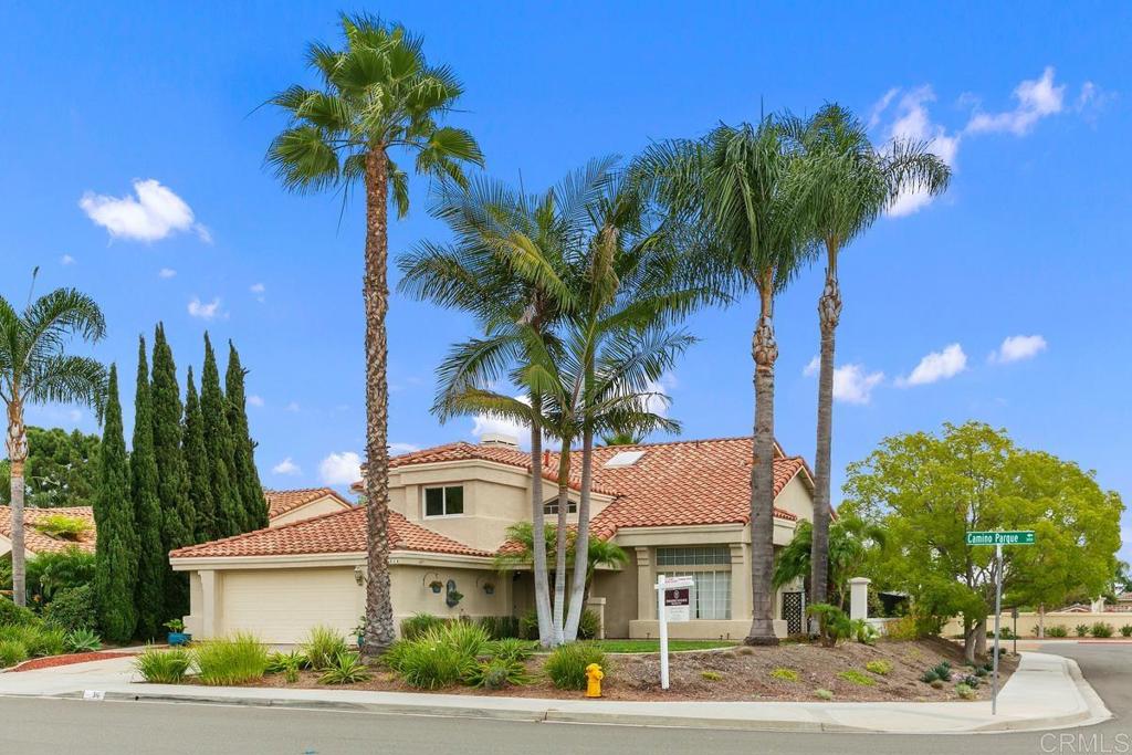 a front view of multiple houses with yard