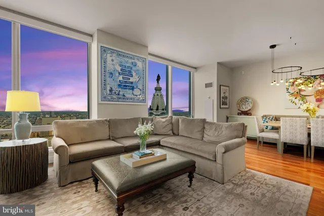 a living room with furniture a rug and a lamp