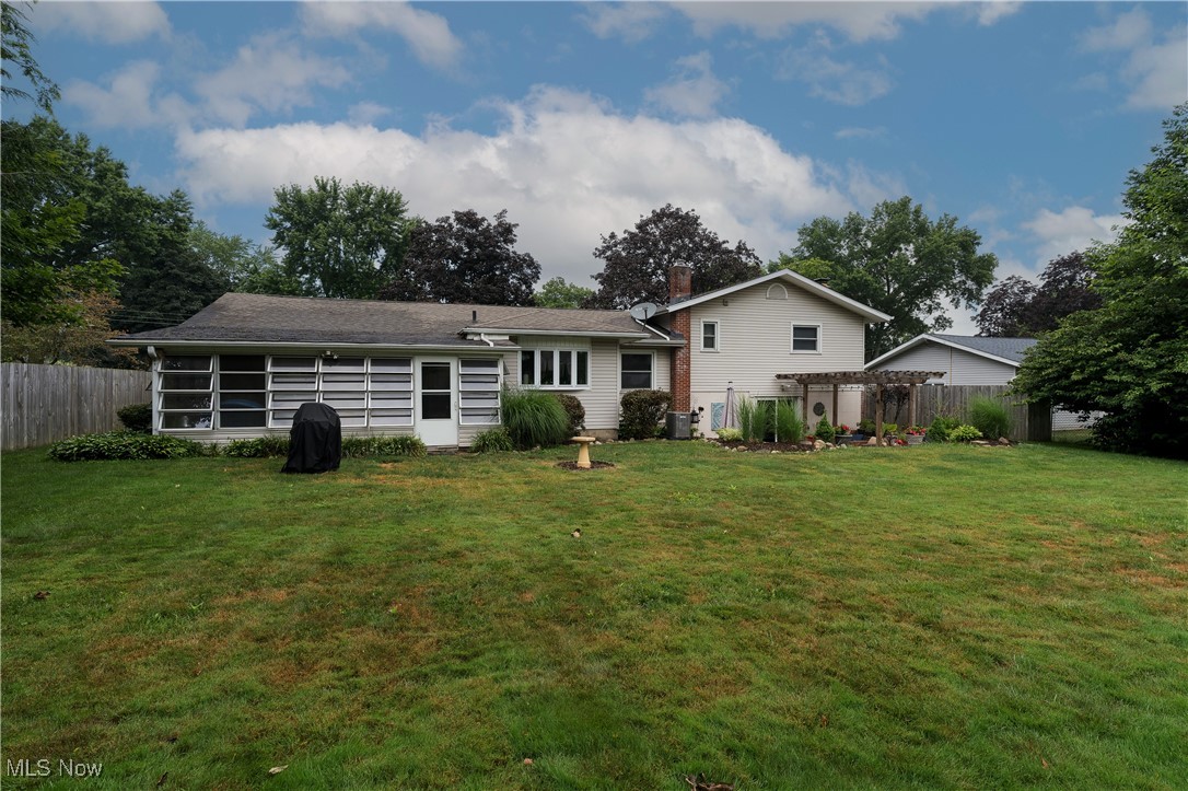 2856 Shellhart Road Barberton, OH 44203 - Photo 5 of 27 Rear view of house featuring a pergola and a shingled roof