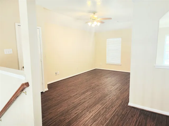 a view of a room with wooden floor
