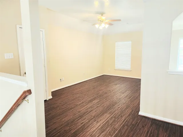 a view of a room with wooden floor