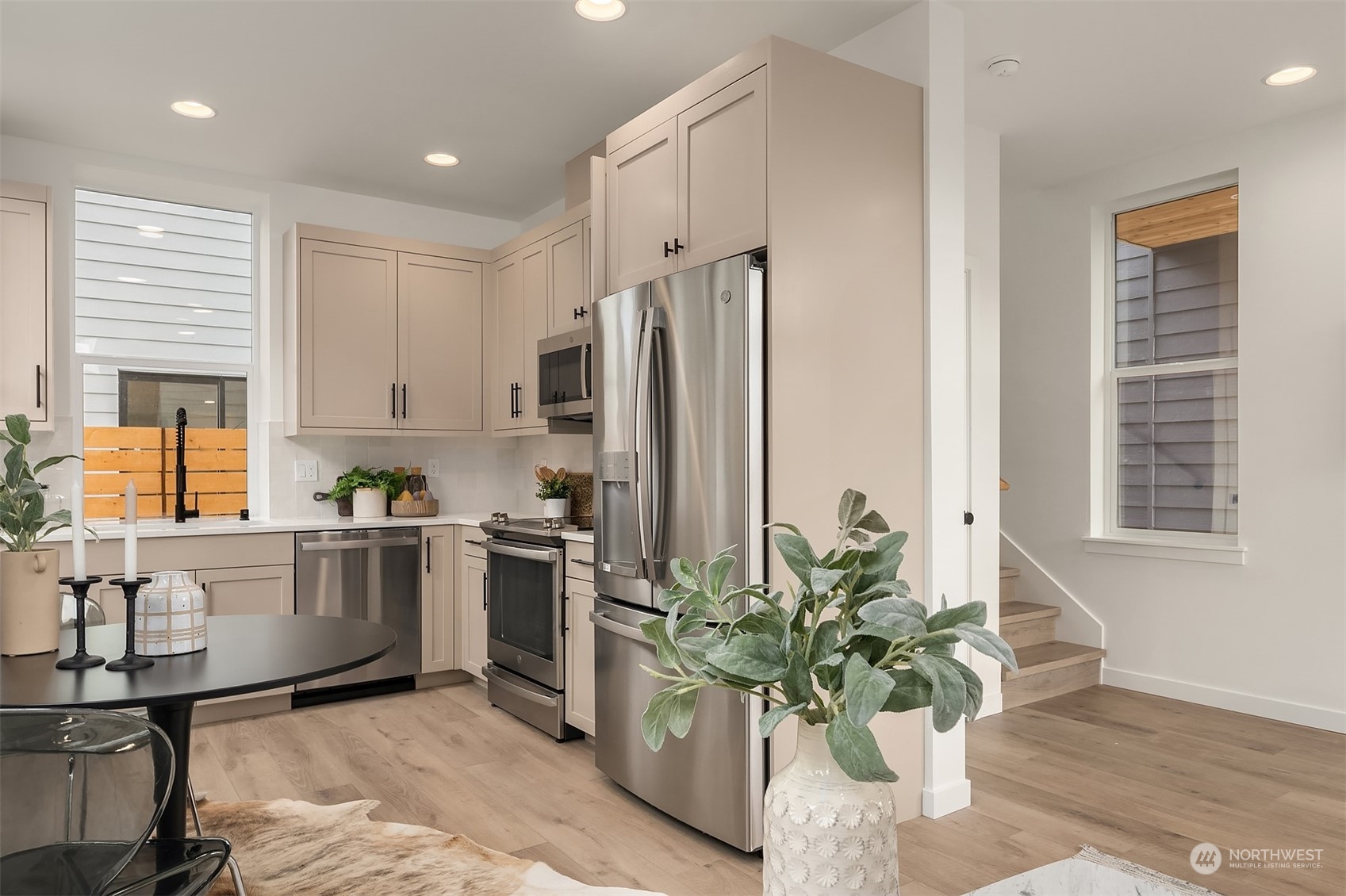 2216 Northeast 75th Street Seattle, WA 98115 - Photo 6 of 23 a kitchen with stainless steel appliances kitchen island granite countertop a refrigerator a stove a sink a window