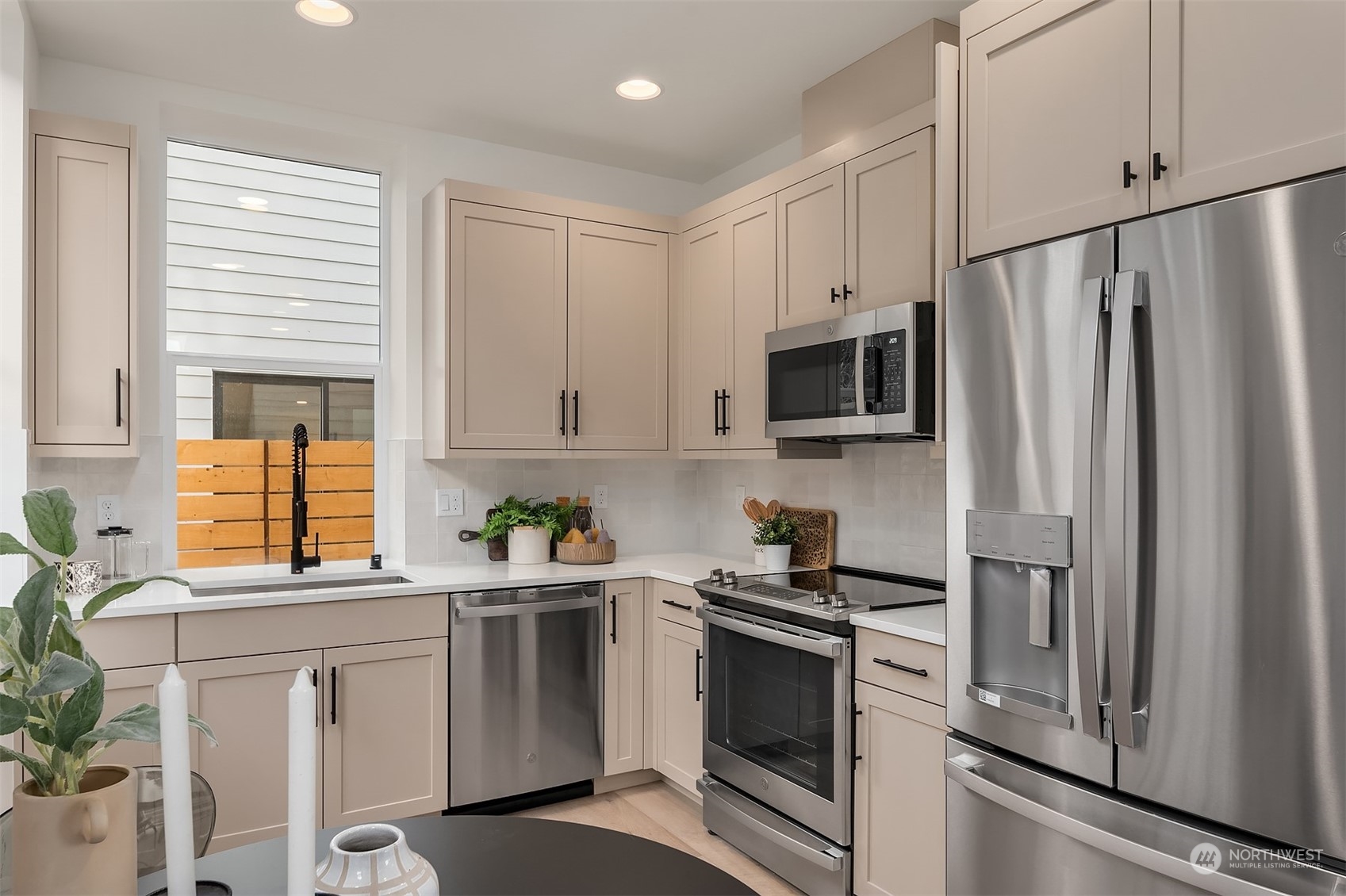 2216 Northeast 75th Street Seattle, WA 98115 - Photo 7 of 23 a kitchen with stainless steel appliances a refrigerator sink and microwave