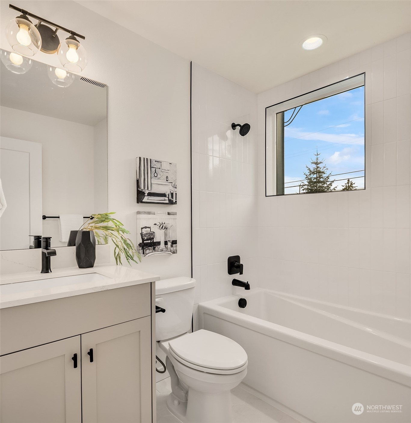 2216 Northeast 75th Street Seattle, WA 98115 - Photo 10 of 23 a bathroom with a toilet a sink a mirror and a bathtub