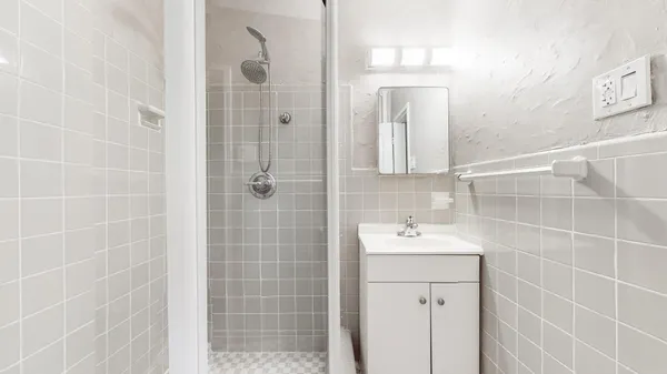 a bathroom with a sink a shower and a mirror