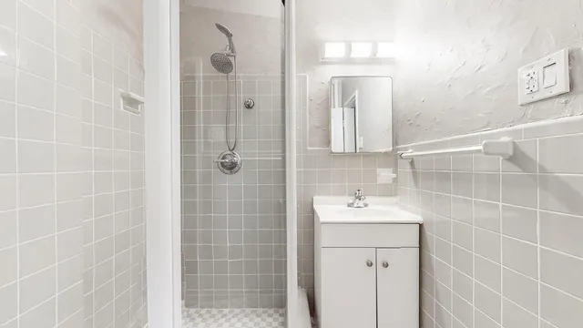 a bathroom with a sink a shower and a mirror