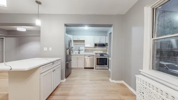 a kitchen with a sink a stove top oven and cabinets