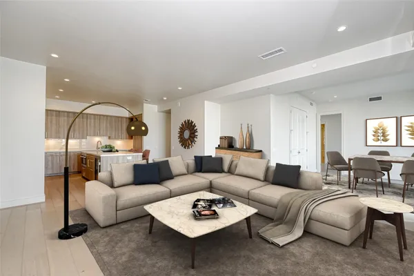 a living room with furniture a rug and a window