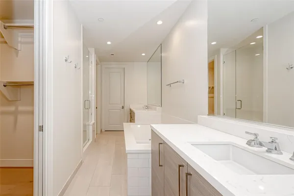 a spacious bathroom with a sink a mirror and a shower