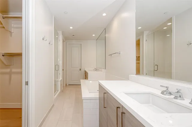 a spacious bathroom with a sink a mirror and a shower