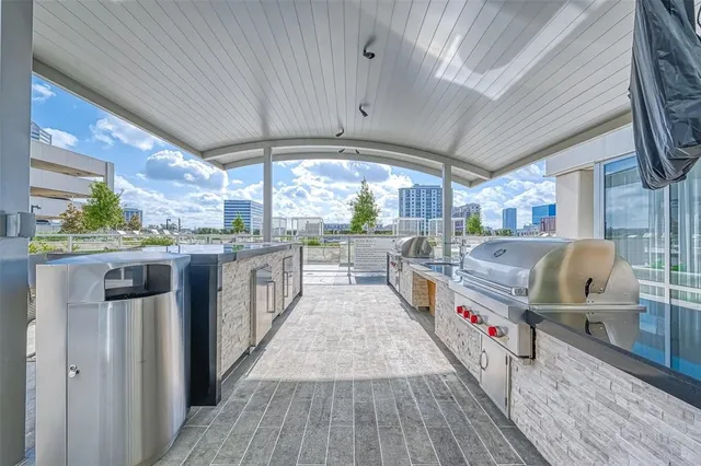 a kitchen with stainless steel appliances granite countertop a large stove a sink dishwasher and cabinets with wooden floor