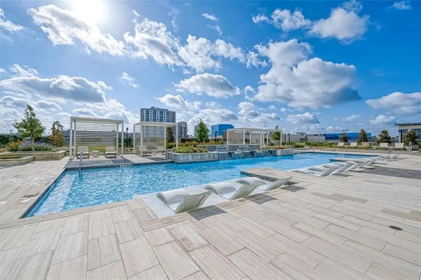 a view of outdoor space with swimming pool and green space