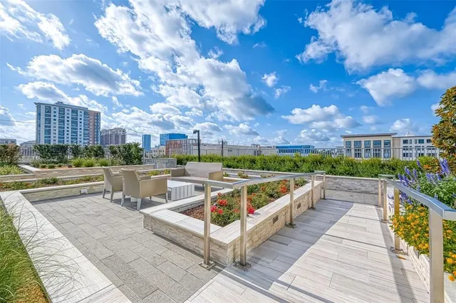 a view of a roof deck with couches and wooden floor