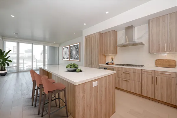 a kitchen with a table chairs refrigerator and cabinets