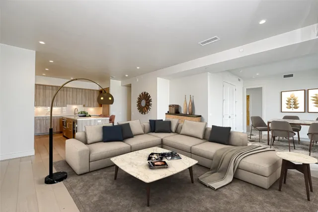 a living room with furniture a rug and a window