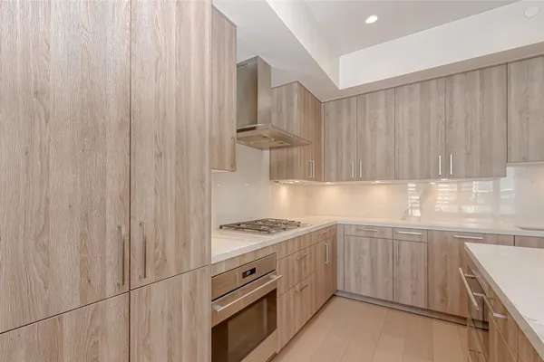 a kitchen with cabinets a stove and a refrigerator