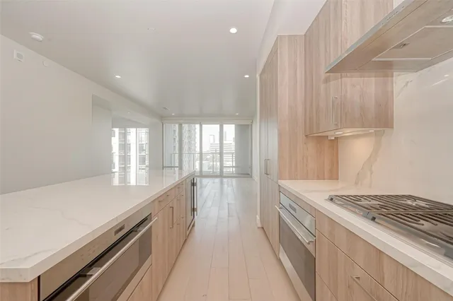 a view of a kitchen with a sink and wooden floor