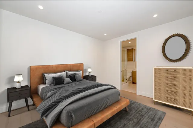 a bedroom with a bed and cabinet