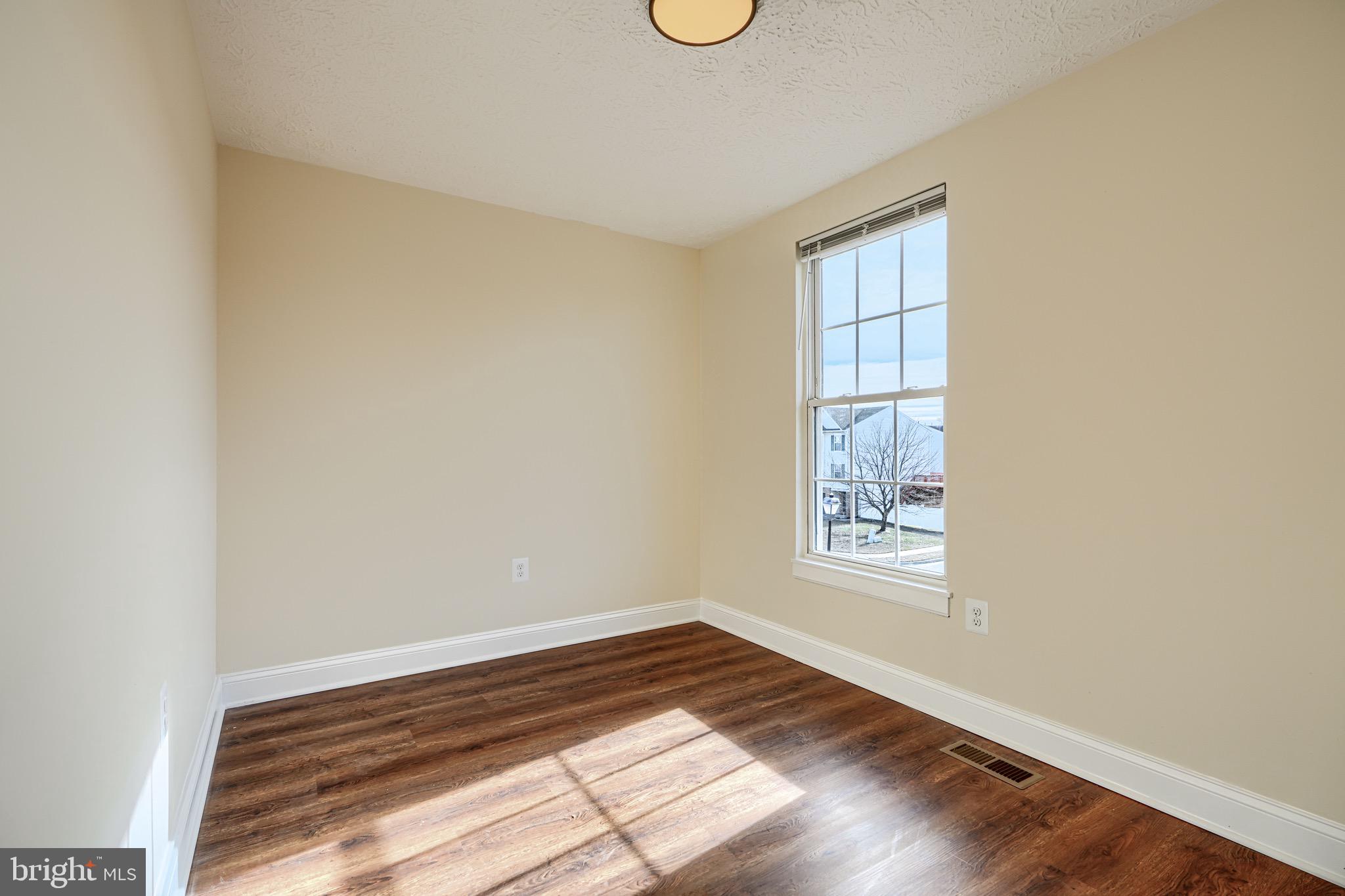 3944 Cutty Sark Road Baltimore, MD 21220 - Photo 16 of 27 a view of empty room with wooden floor and fan