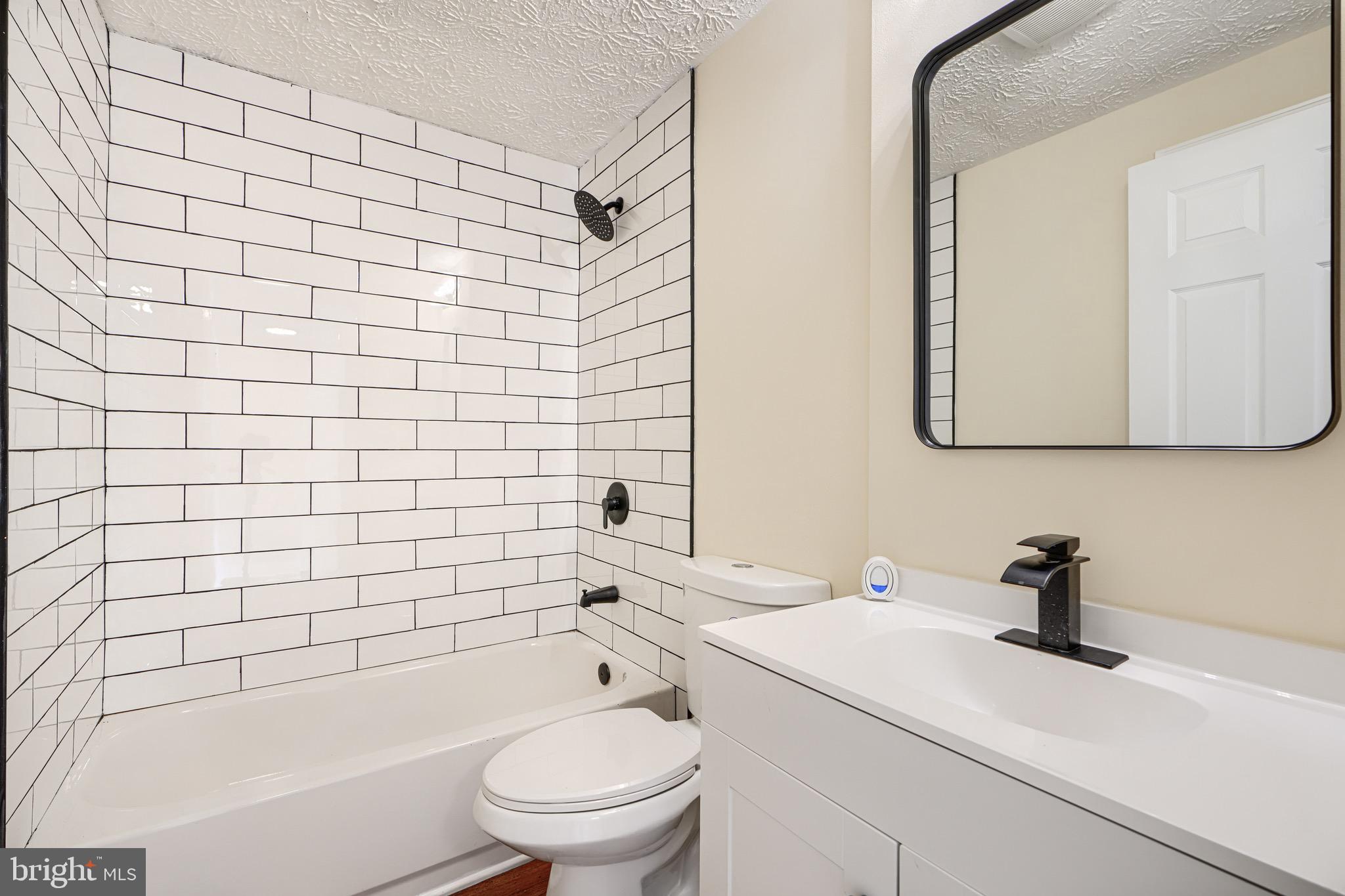 3944 Cutty Sark Road Baltimore, MD 21220 - Photo 19 of 27 a bathroom with a sink a toilet and shower