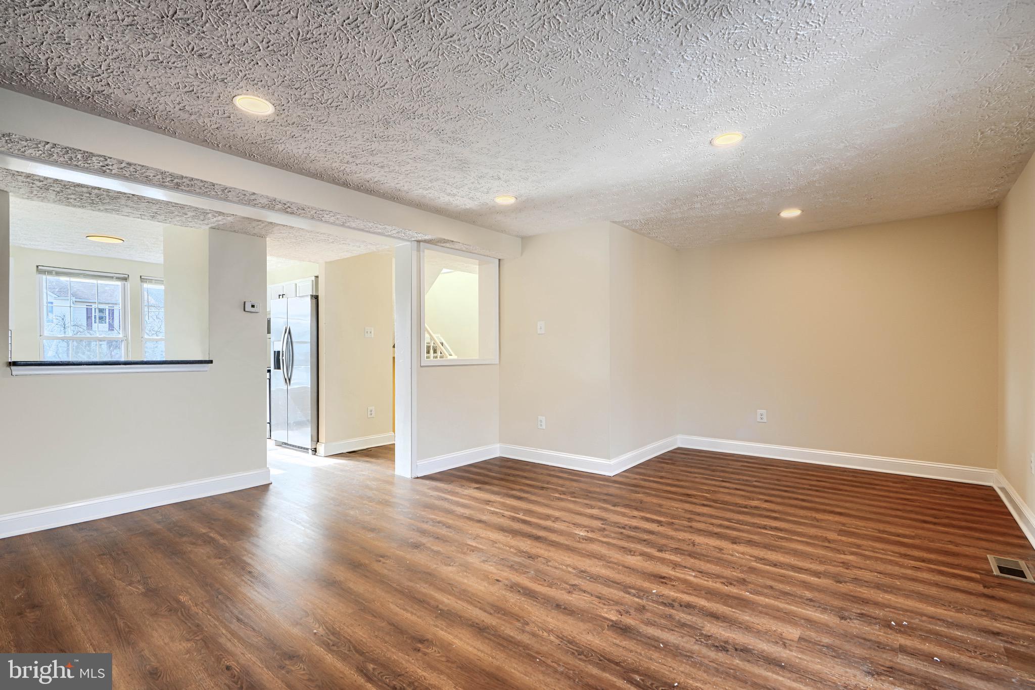 3944 Cutty Sark Road Baltimore, MD 21220 - Photo 4 of 27 wooden floor in an empty room with a window