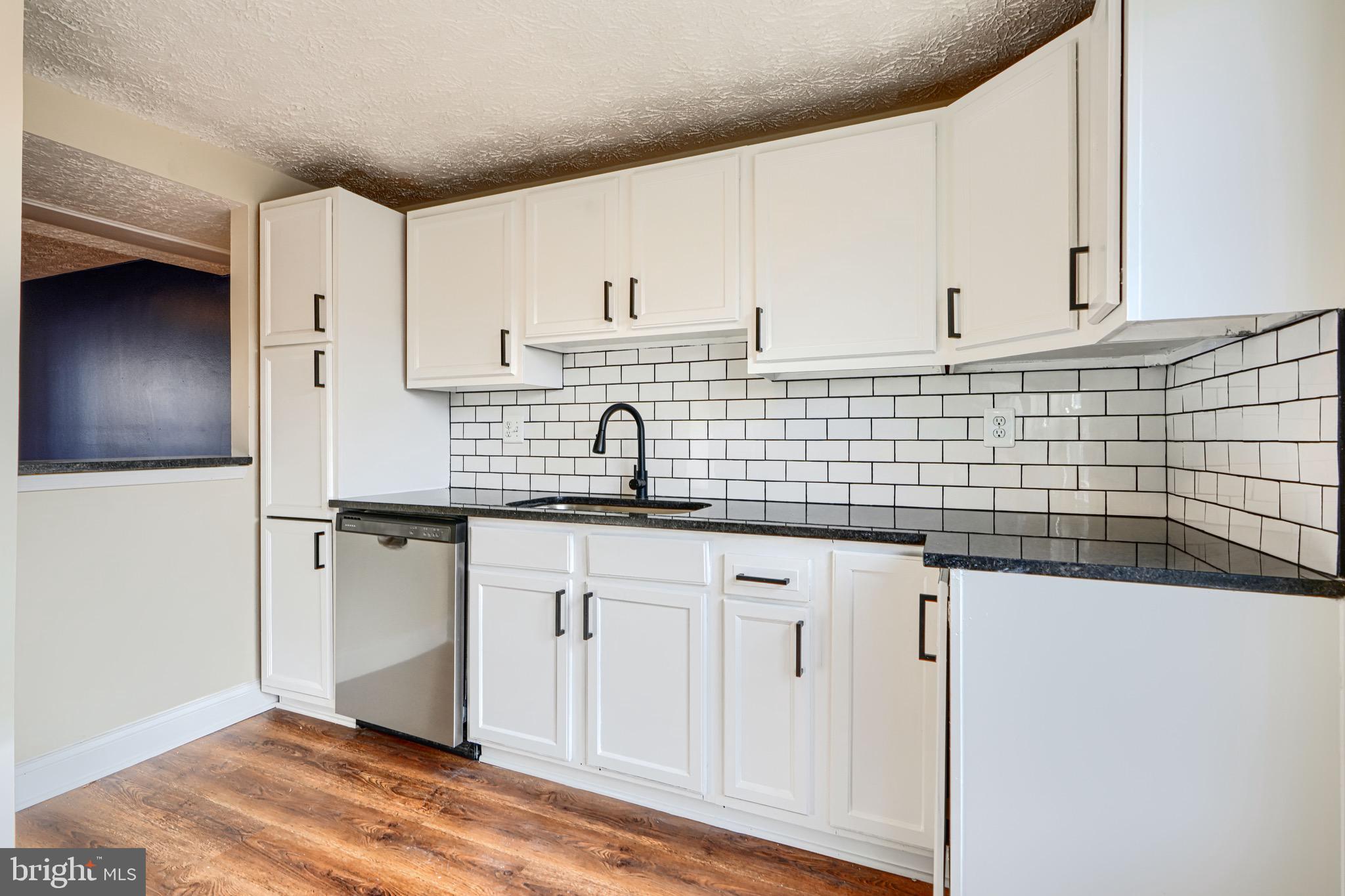3944 Cutty Sark Road Baltimore, MD 21220 - Photo 5 of 27 a kitchen with stainless steel appliances granite countertop a sink and cabinets