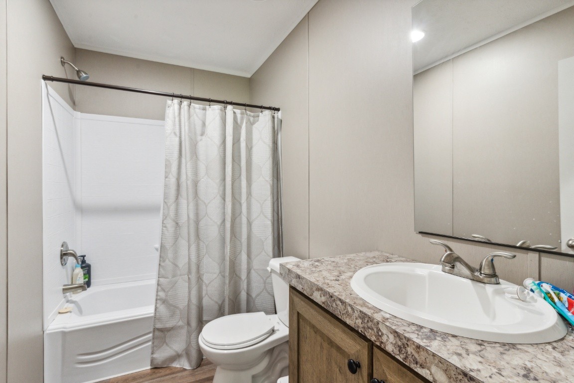 235 Antioch Road Lafayette, TN 37083 - Photo 14 of 17 a bathroom with a granite countertop sink toilet and shower