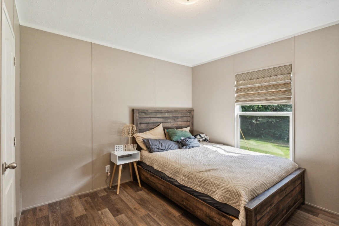 235 Antioch Road Lafayette, TN 37083 - Photo 17 of 17 a bed sitting in a bedroom next to a window
