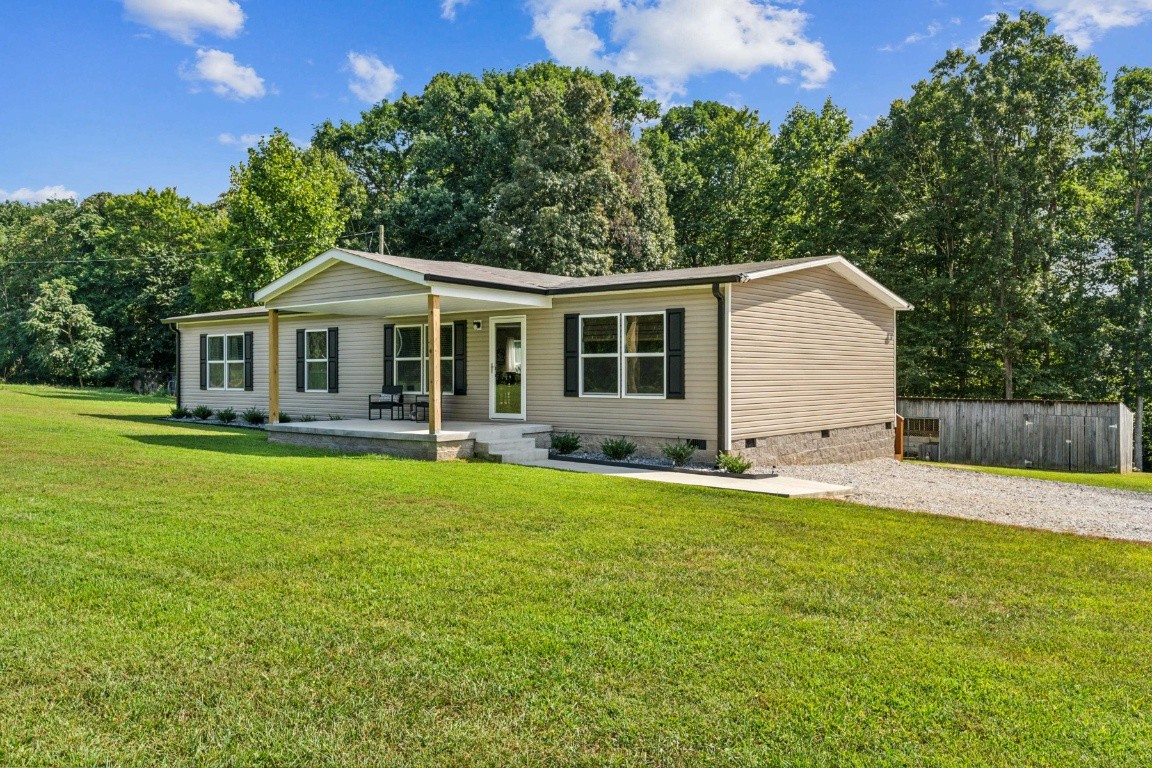 235 Antioch Road Lafayette, TN 37083 - Photo 2 of 17 a front view of a house with a garden