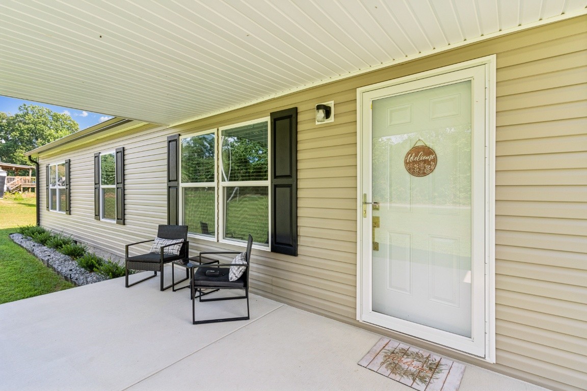 235 Antioch Road Lafayette, TN 37083 - Photo 3 of 17 a building outdoor space with patio furniture and garden
