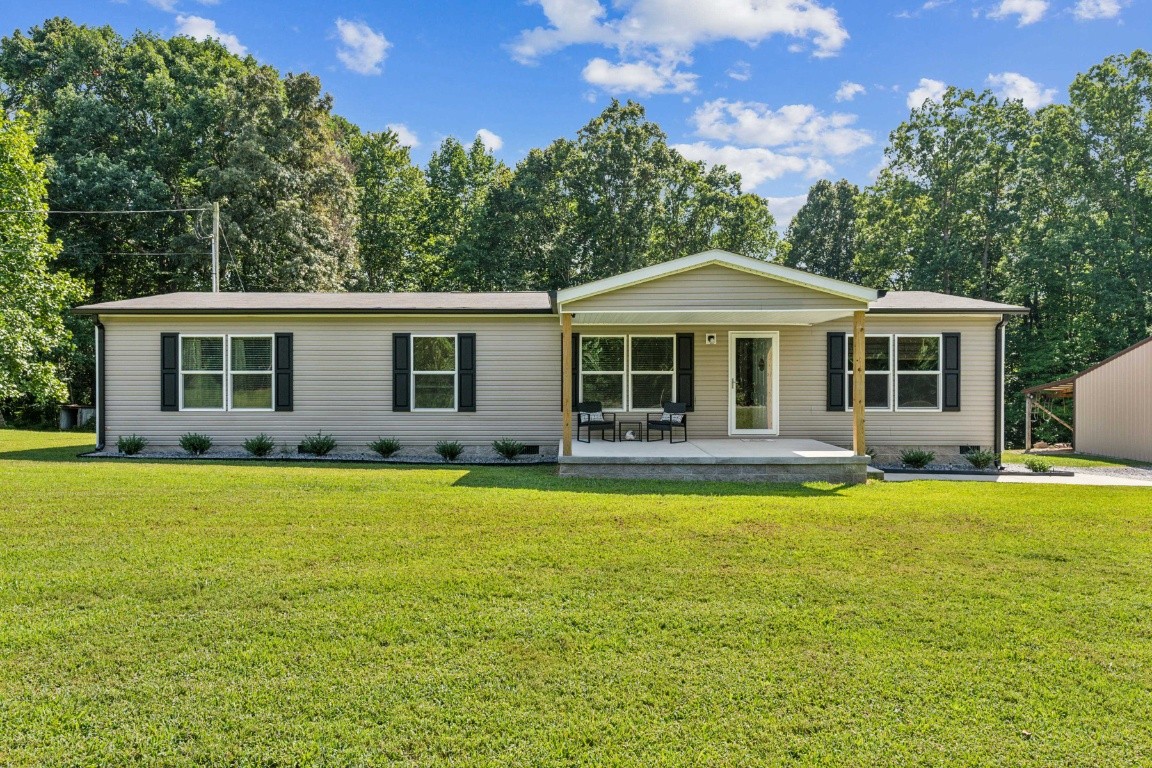 235 Antioch Road Lafayette, TN 37083 - Photo 4 of 17 a front view of a house with swimming pool having outdoor seating