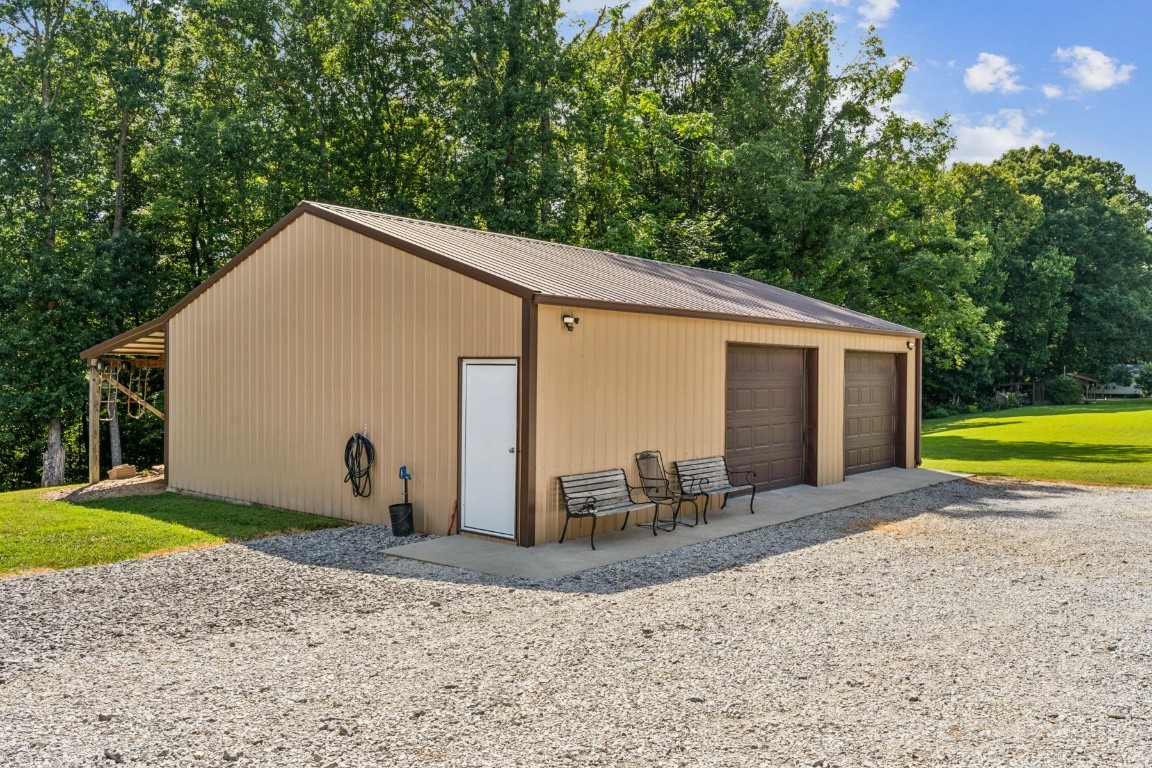 235 Antioch Road Lafayette, TN 37083 - Photo 7 of 17 a view of a house with backyard and trees