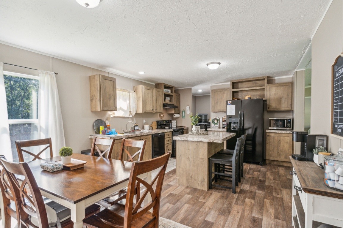 235 Antioch Road Lafayette, TN 37083 - Photo 9 of 17 a kitchen with a dining table chairs and refrigerator