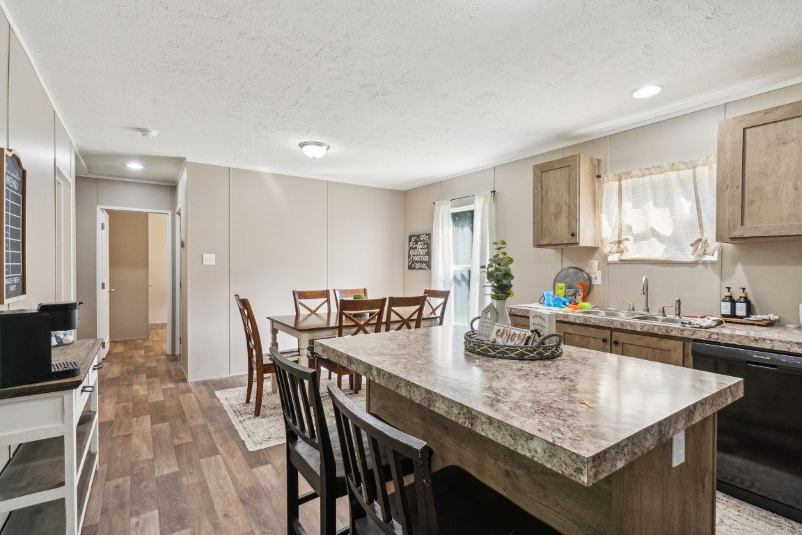 235 Antioch Road Lafayette, TN 37083 - Photo 10 of 17 a kitchen with granite countertop kitchen island a table and chairs in it