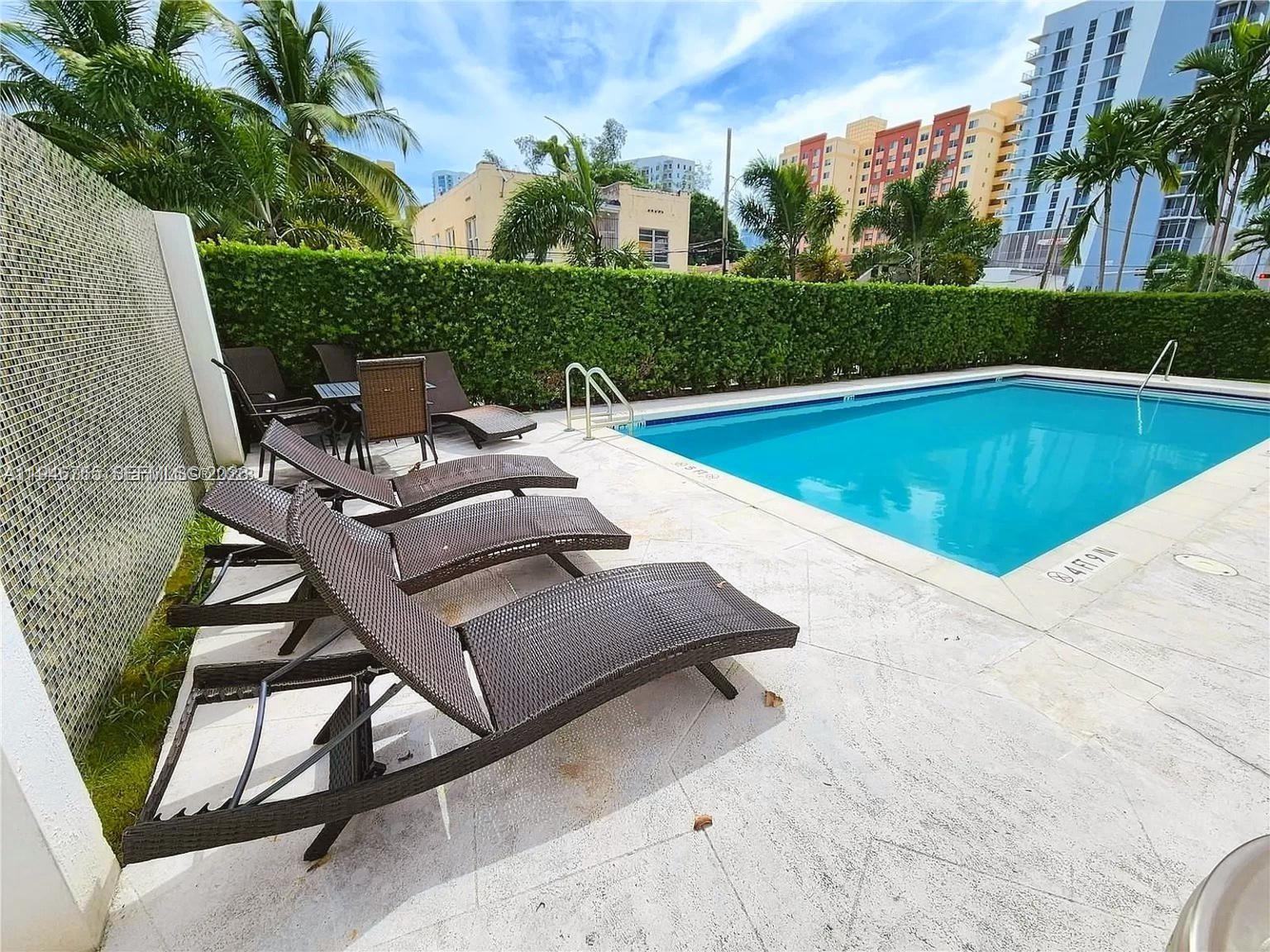36 Northwest 6th Avenue, Unit 1106 Miami, FL 33128 - Photo 34 of 34 a view of swimming pool with outdoor seating and plants